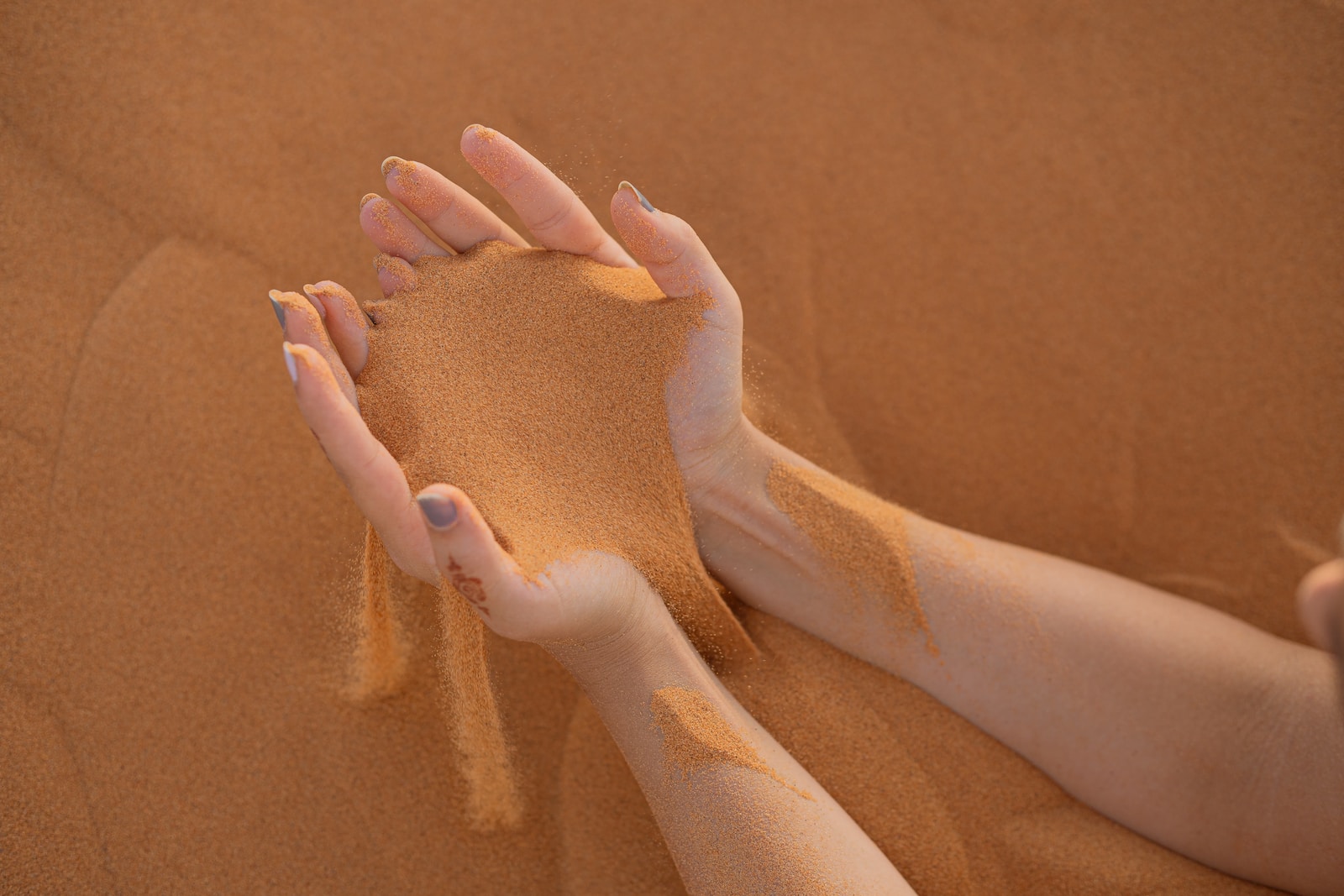 persons feet on brown sand