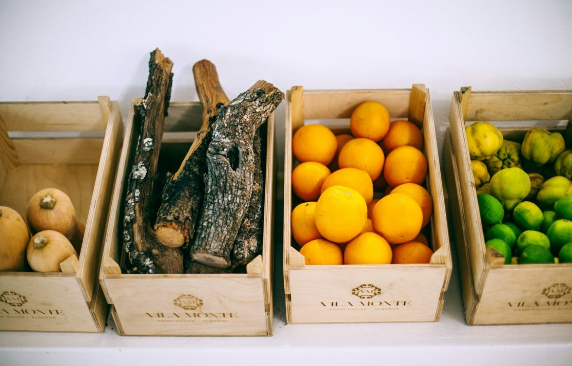 assorted fruits on brown wooden crates