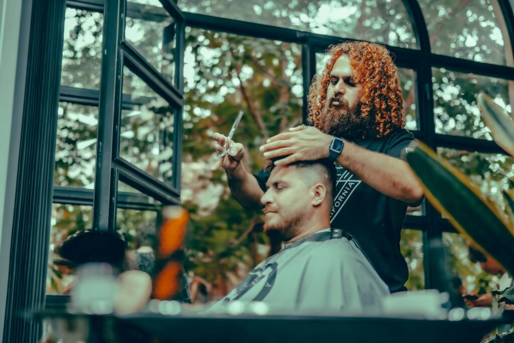 Barber giving a haircut to his customer.